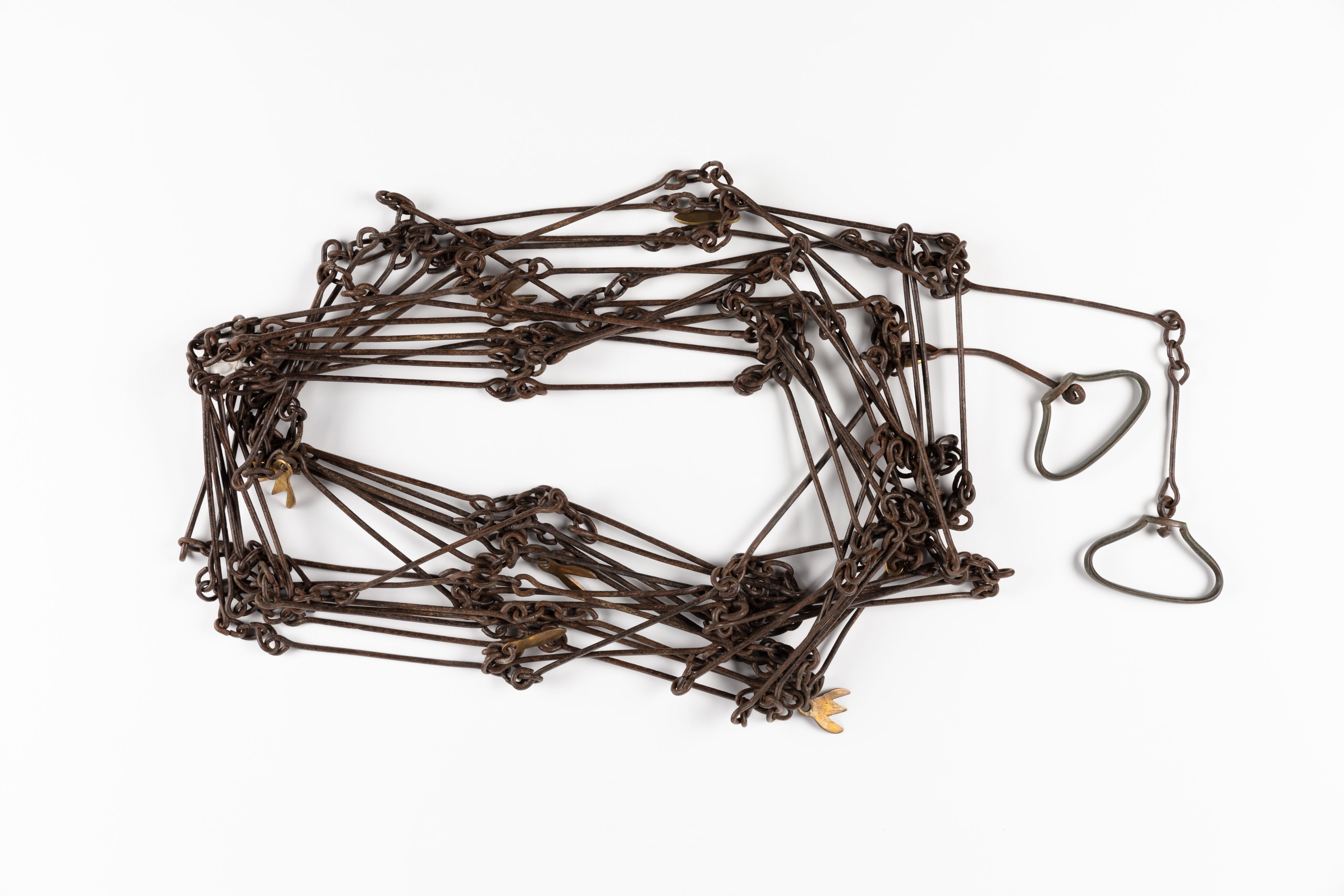 Surveyor's chain made from equally spaced steel links with brass markers in the form of one, two, three and four 'fingers'.