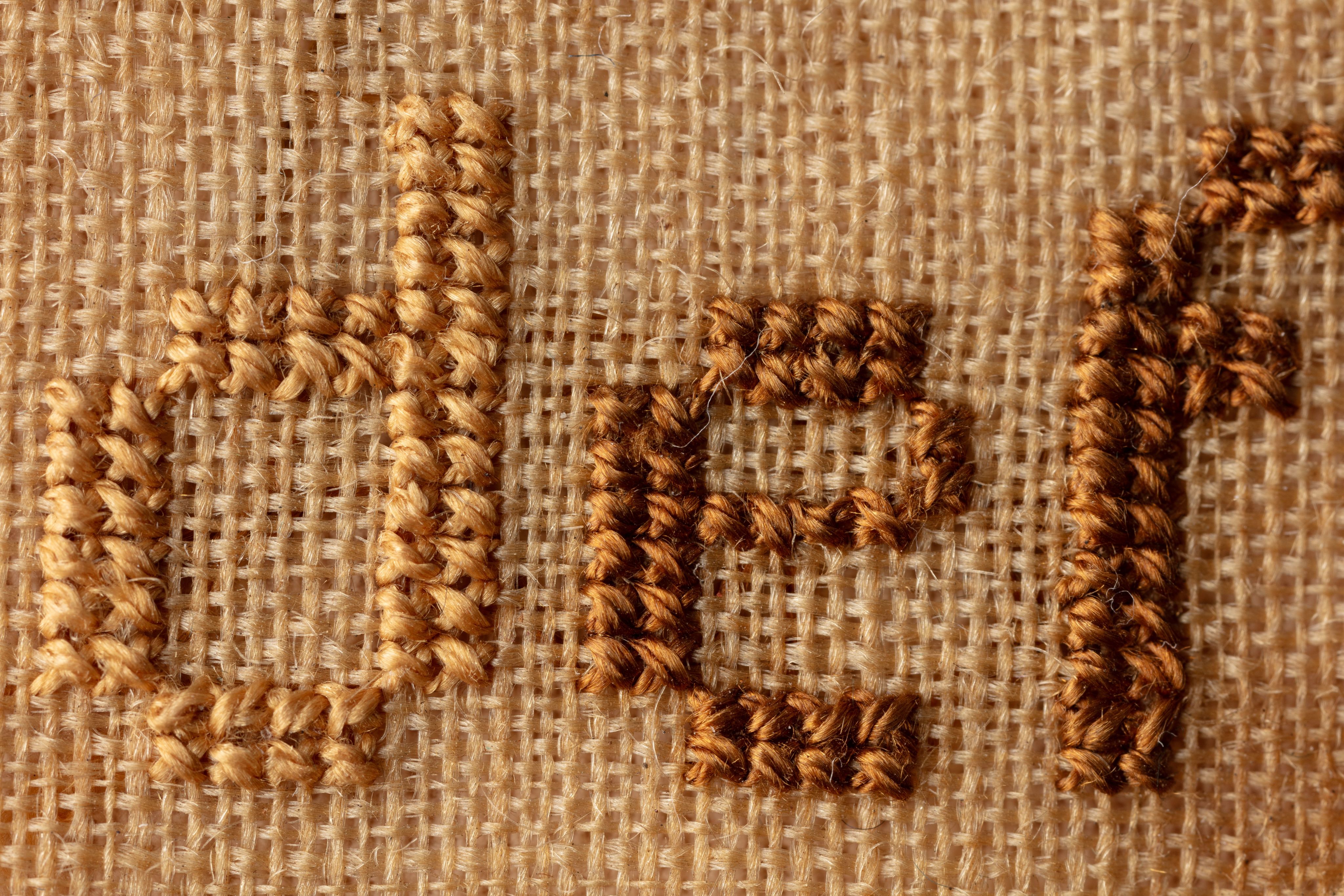 fine cloth, finely stitched sampler with texts, alphabets, numerals, and motifs.