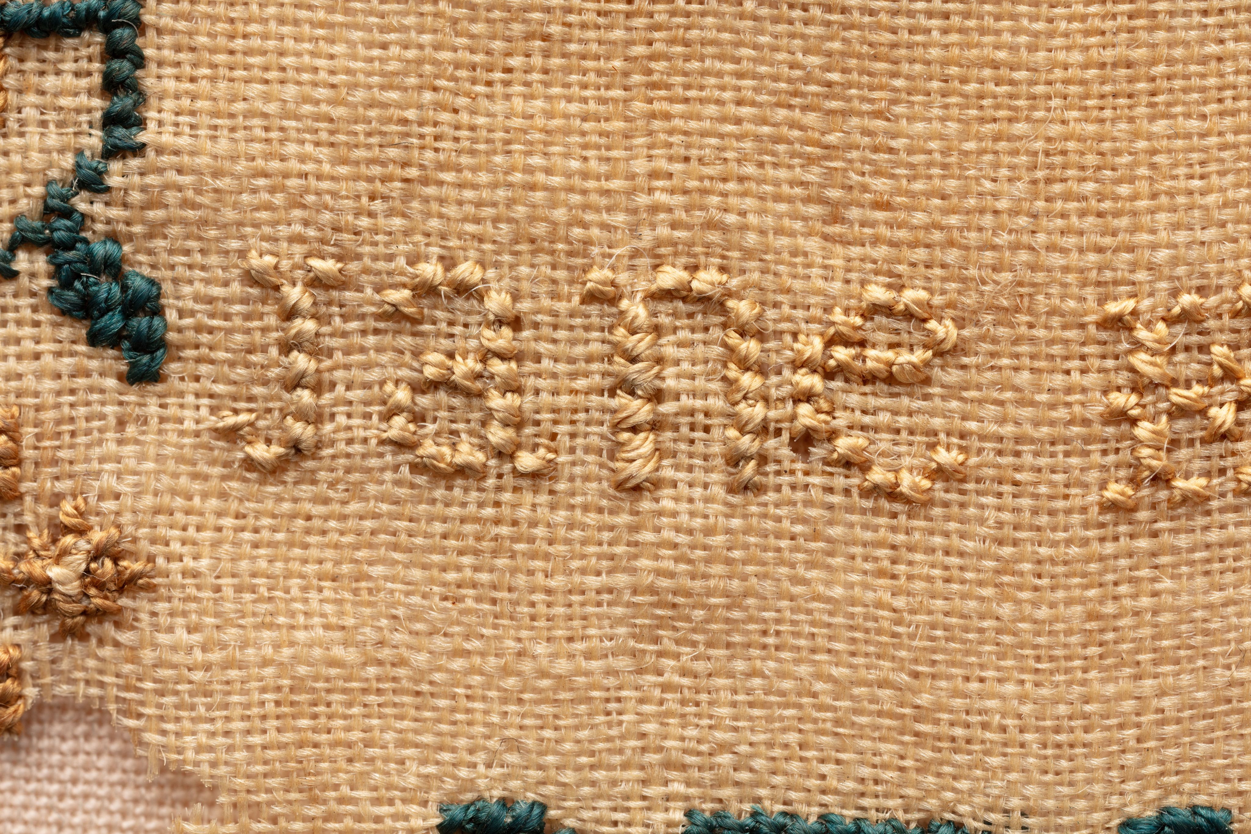 fine cloth, finely stitched sampler with texts, alphabets, numerals, and motifs.
