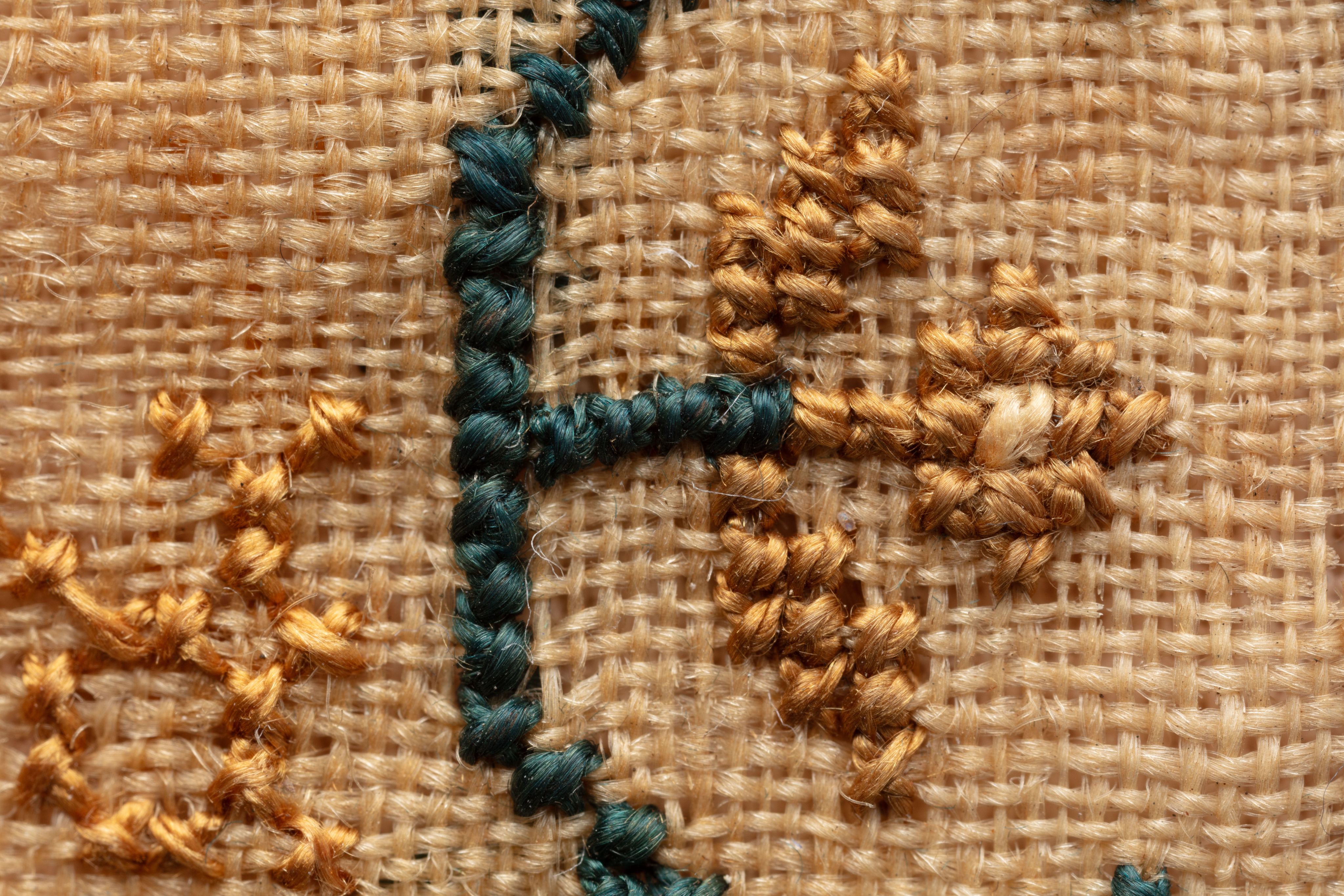 fine cloth, finely stitched sampler with texts, alphabets, numerals, and motifs.