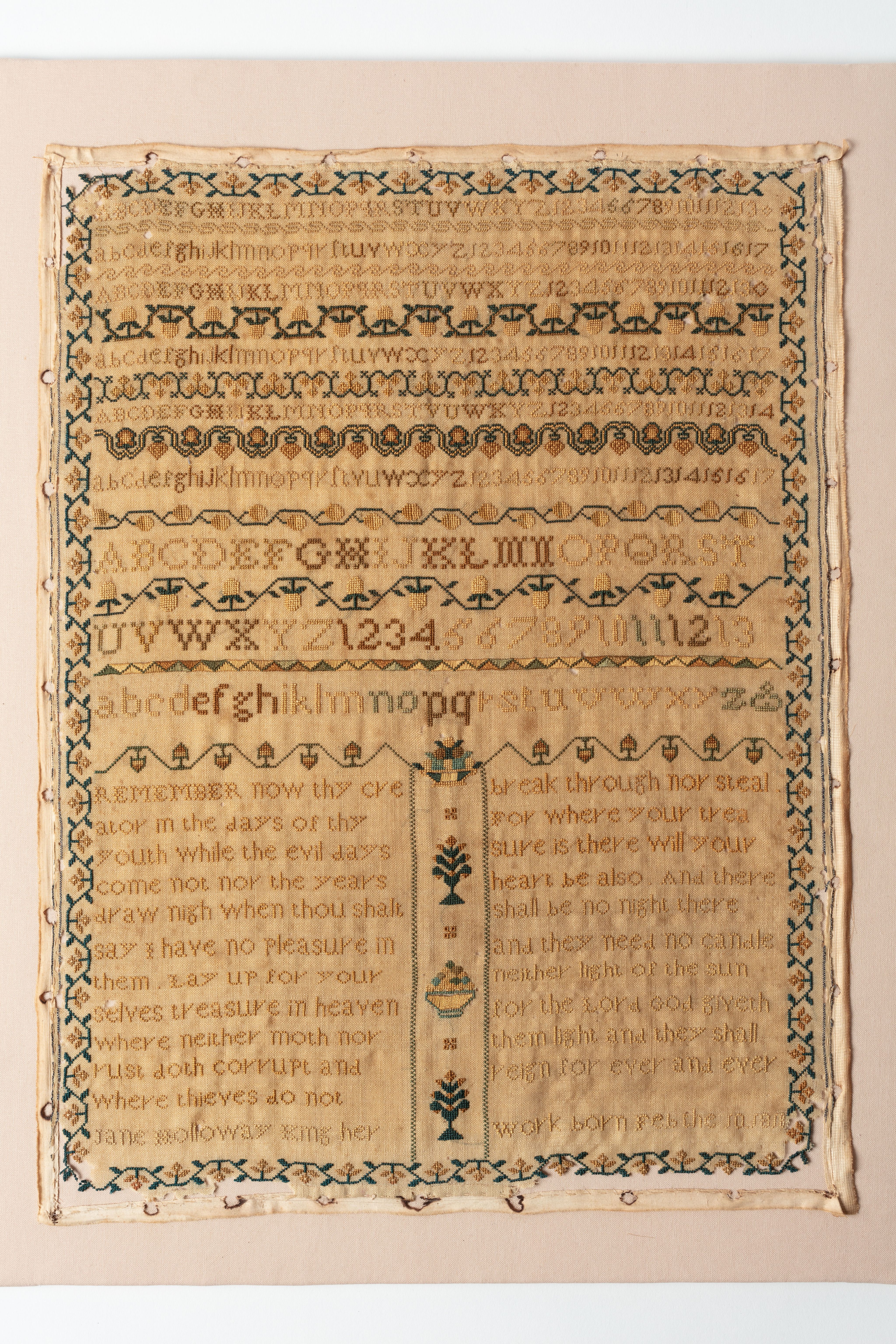 fine cloth, finely stitched sampler with texts, alphabets, numerals, and motifs.