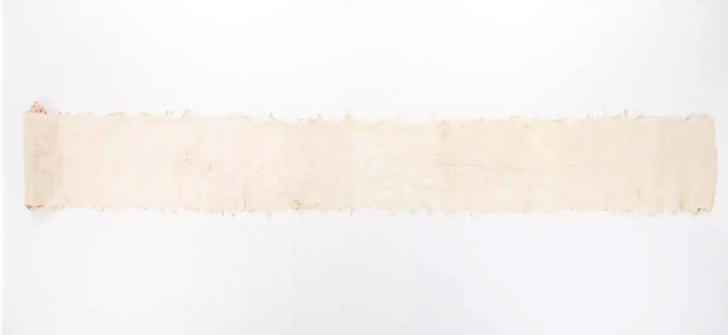 Fine mat made from pandanus (leaf) with "X MULI X OAIGA X" written the edge in ink. Red feathers are featured along the border of mat.