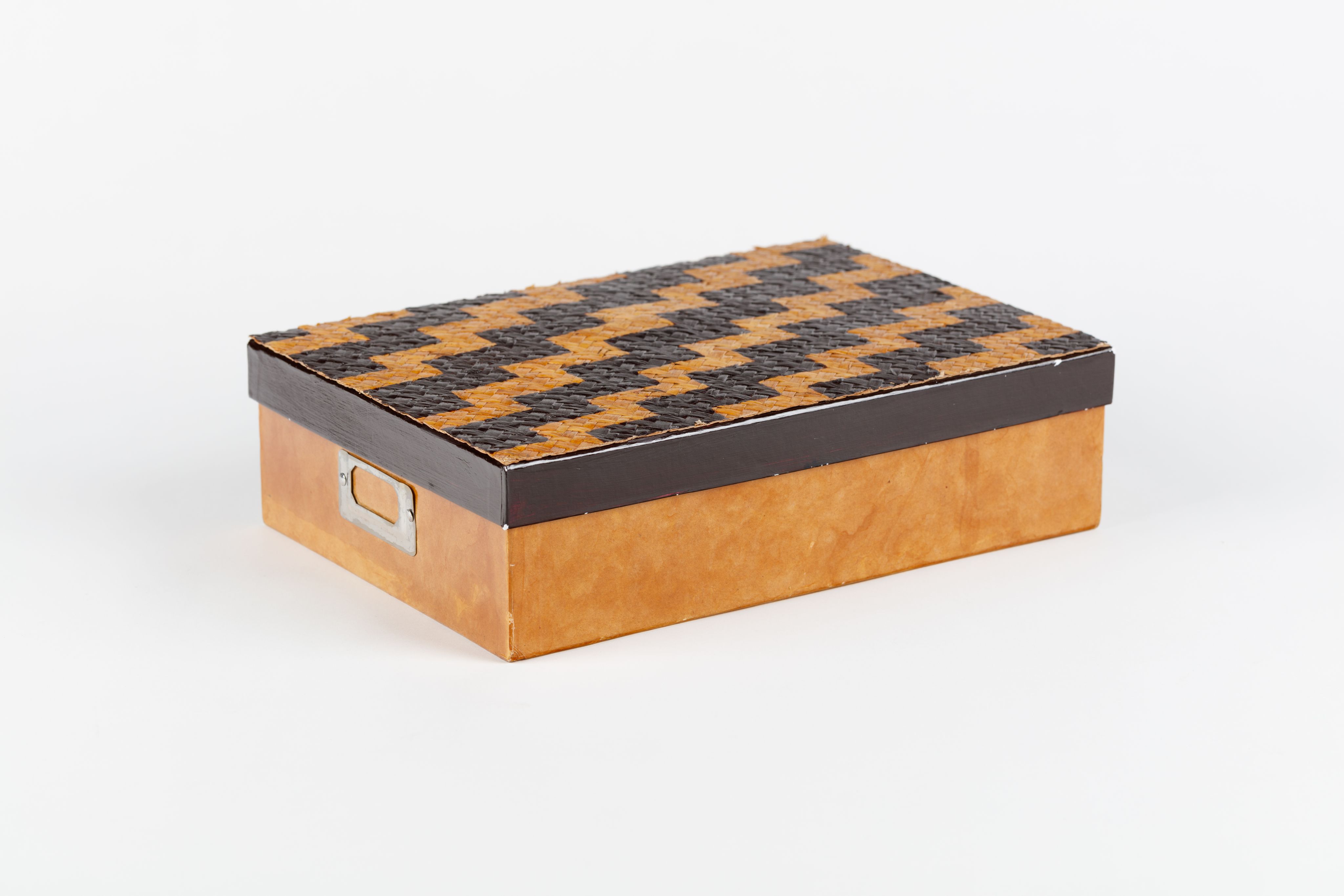 cardboard box with woven lid decorated with poutama (stairway) design