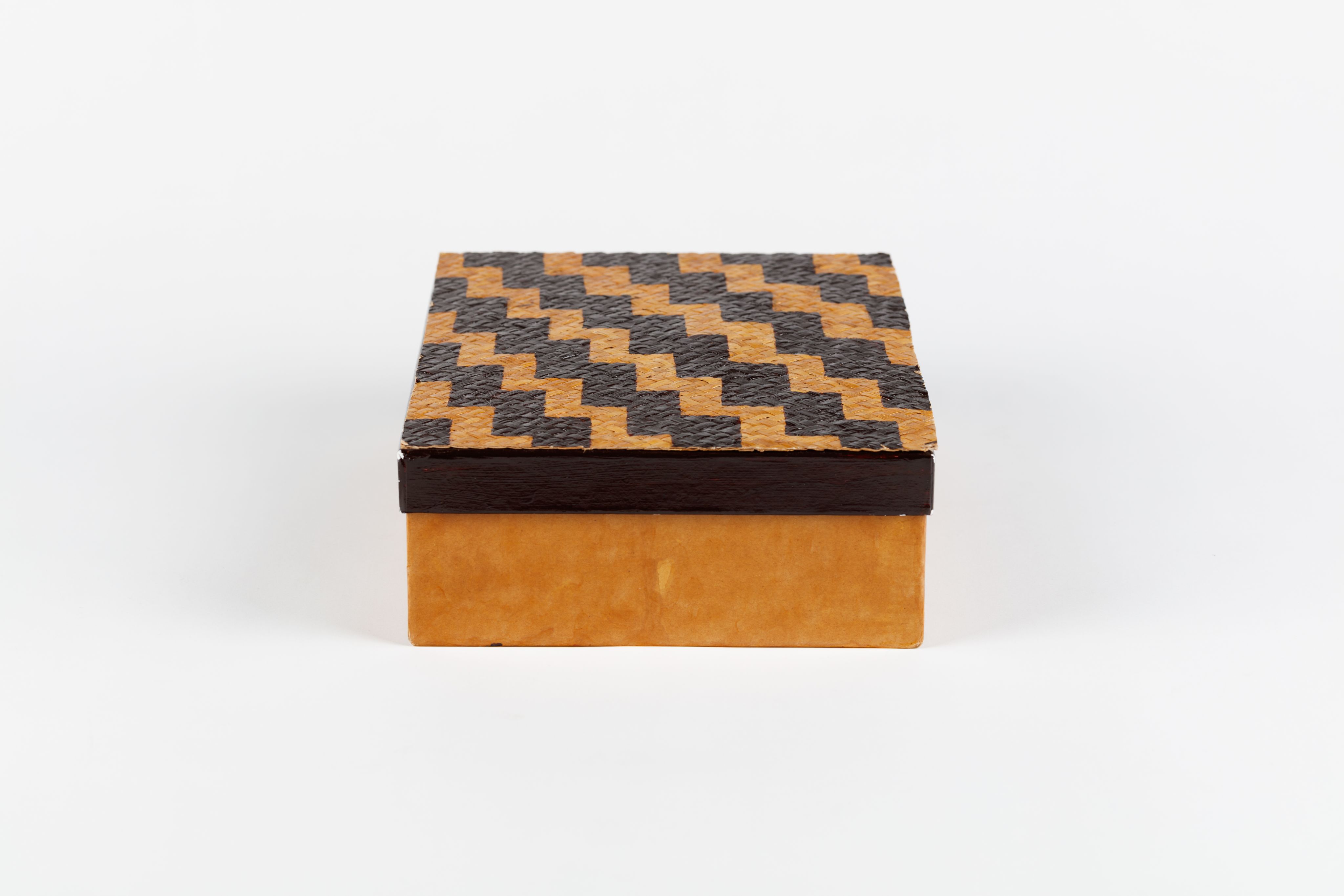 cardboard box with lid decorated with poutama (stairway) design