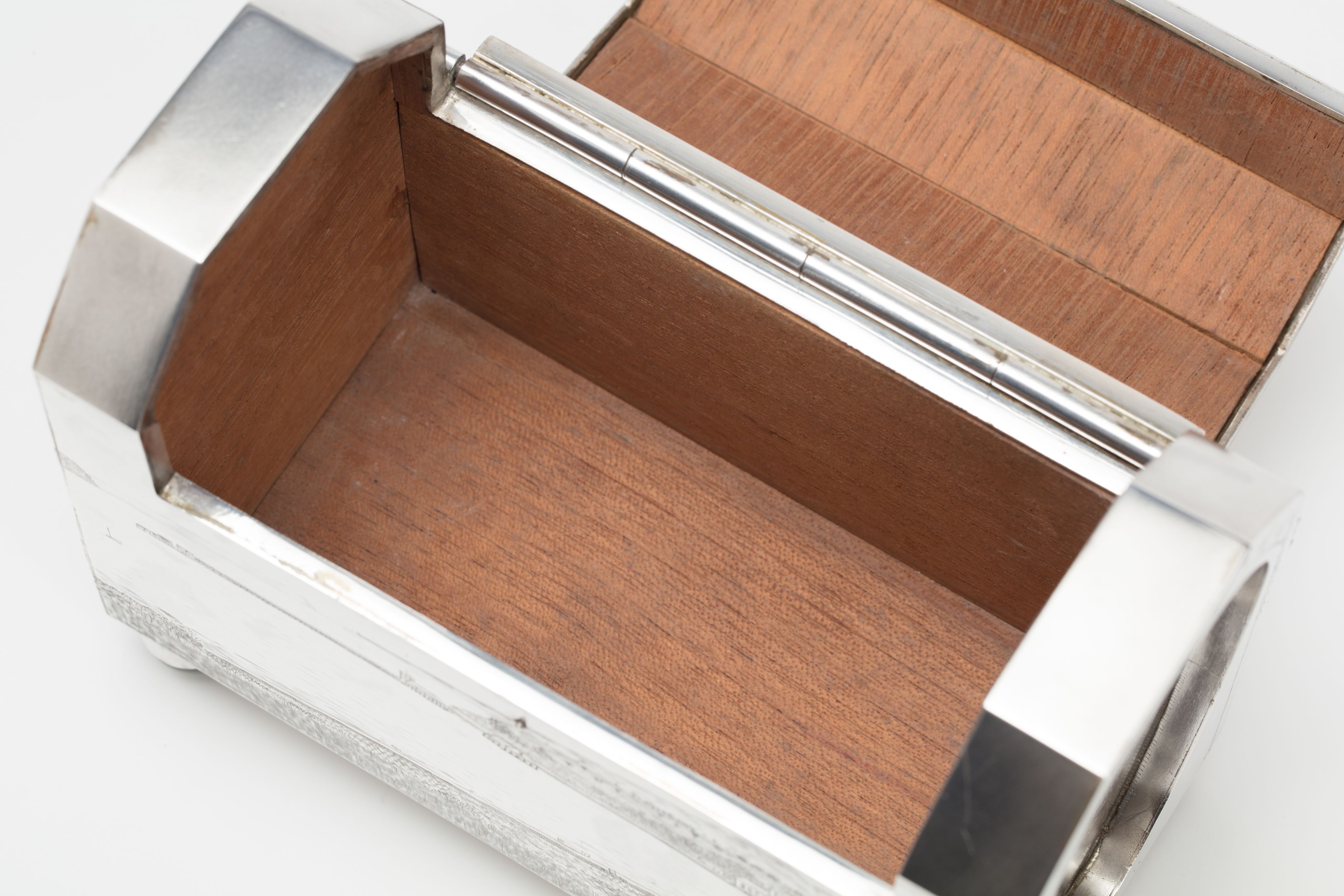 Finely crafted silver box (or casket) designed in the shape of the main sewage pipe, engraved with the names of the members of the drainage board along with technical sewage . On one side there is an engraved illustration of Ōkahu Bay, showing the Ngāti Whātua Ōrākei papakāinga and the newly installed sewer pipe running along the foreshore in front of it.