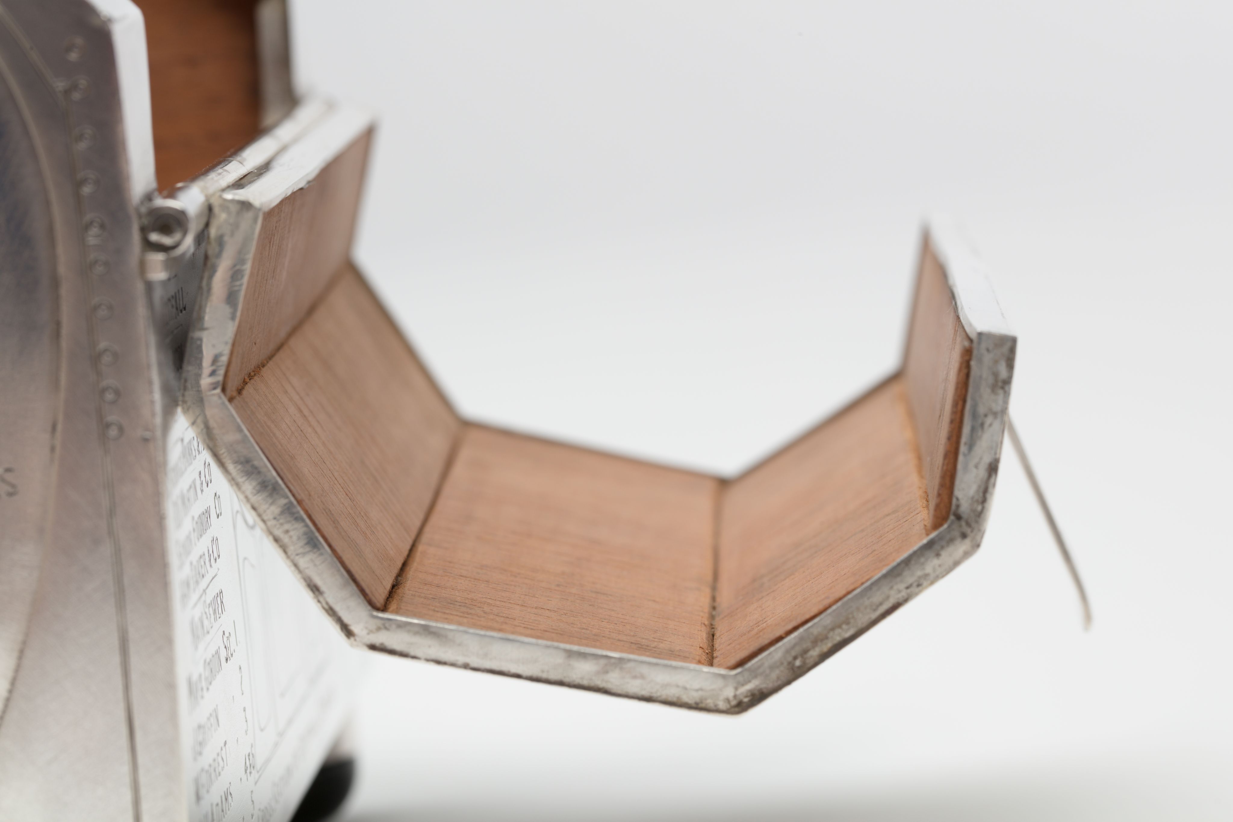 Finely crafted silver box (or casket) designed in the shape of the main sewage pipe, engraved with the names of the members of the drainage board along with technical sewage . On one side there is an engraved illustration of Ōkahu Bay, showing the Ngāti Whātua Ōrākei papakāinga and the newly installed sewer pipe running along the foreshore in front of it.