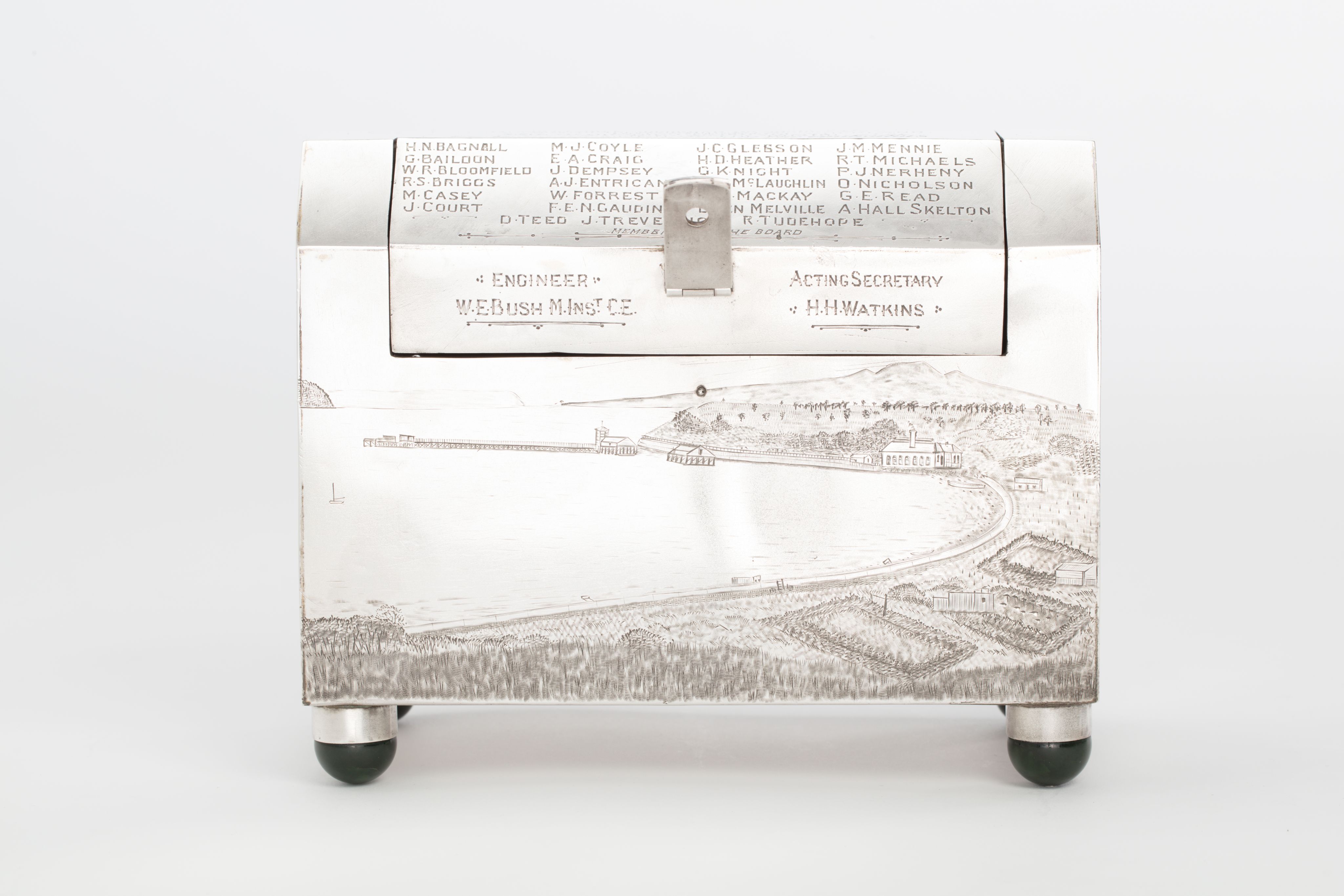 Finely crafted silver box (or casket) designed in the shape of the main sewage pipe, engraved with the names of the members of the drainage board along with technical sewage . On one side there is an engraved illustration of Ōkahu Bay, showing the Ngāti Whātua Ōrākei papakāinga and the newly installed sewer pipe running along the foreshore in front of it.