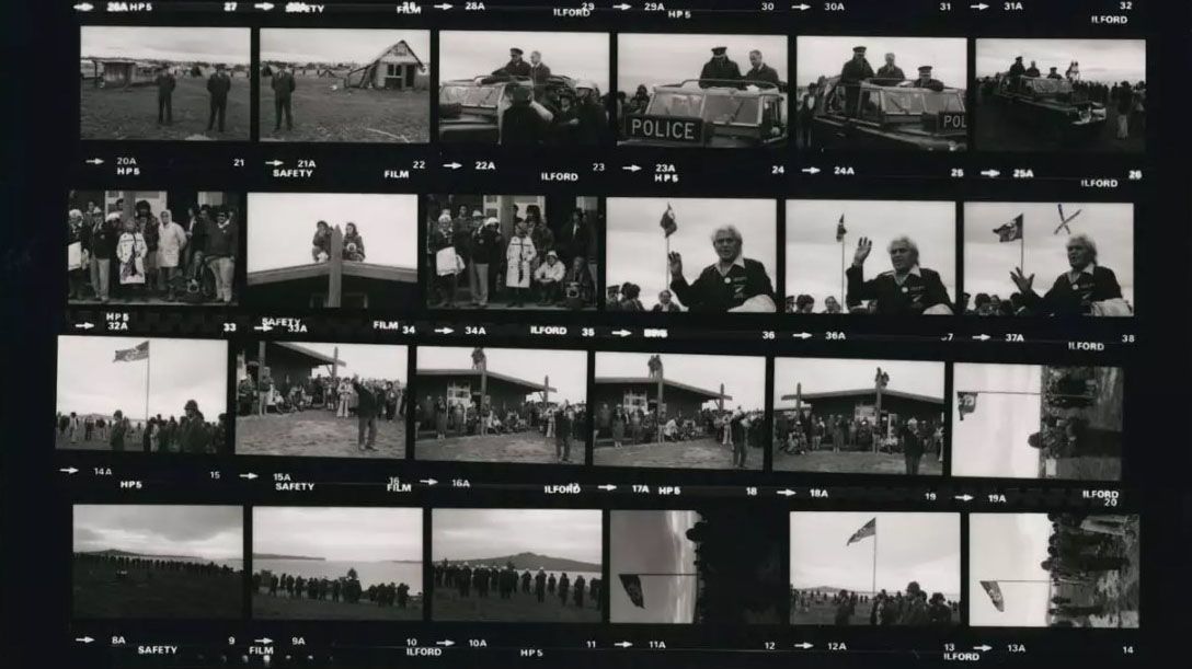 Photography negatives of Point/Takaparawhau including frames of Tumanako Reweti (Auntie Hope), Prince Davis and other unidentified protestors. Various frames of military vehicles and Police in formation. Five frames of two people standing on the roof.