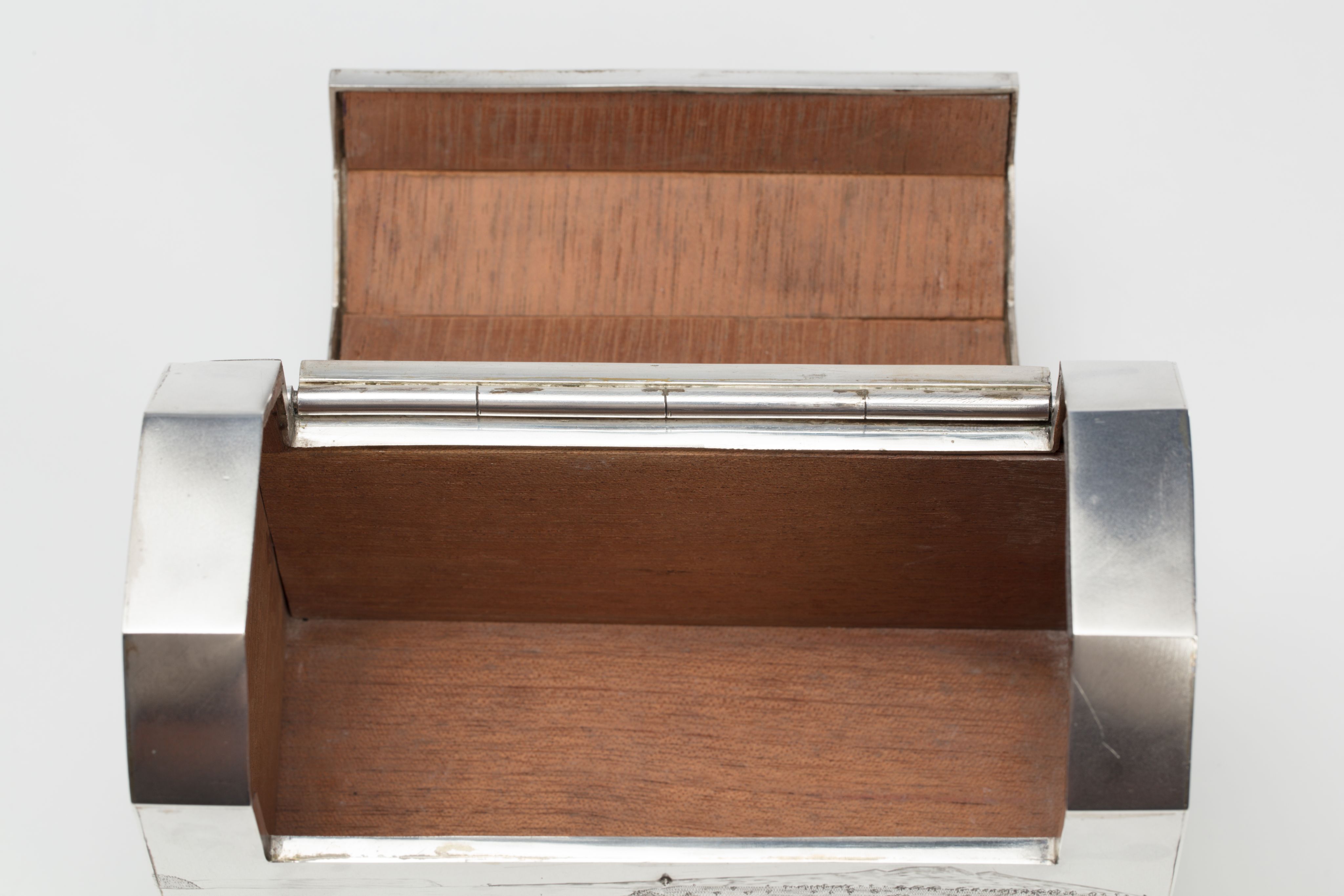 Finely crafted silver box (or casket) designed in the shape of the main sewage pipe, engraved with the names of the members of the drainage board along with technical sewage . On one side there is an engraved illustration of Ōkahu Bay, showing the Ngāti Whātua Ōrākei papakāinga and the newly installed sewer pipe running along the foreshore in front of it.