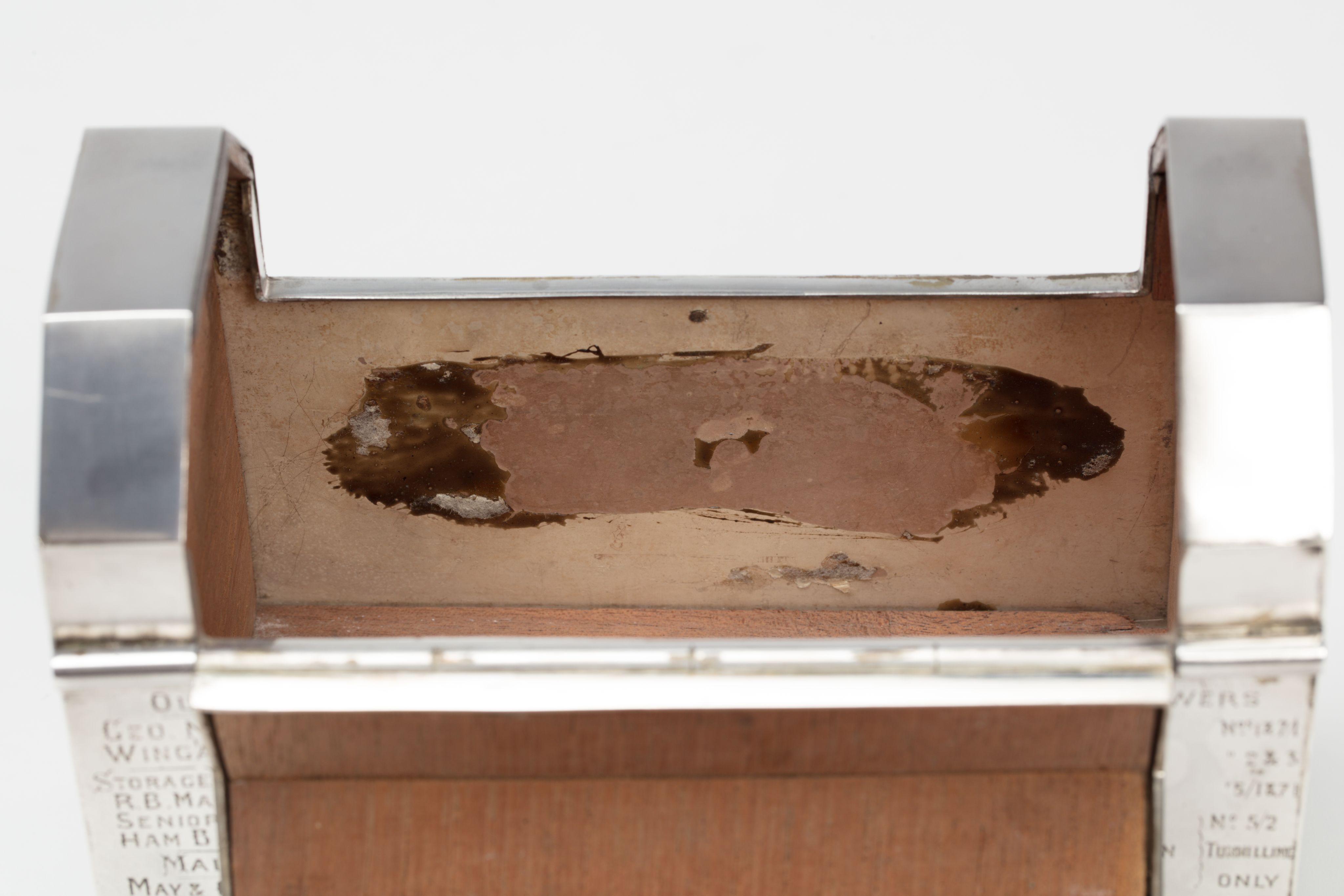 Finely crafted silver box (or casket) designed in the shape of the main sewage pipe, engraved with the names of the members of the drainage board along with technical sewage . On one side there is an engraved illustration of Ōkahu Bay, showing the Ngāti Whātua Ōrākei papakāinga and the newly installed sewer pipe running along the foreshore in front of it.