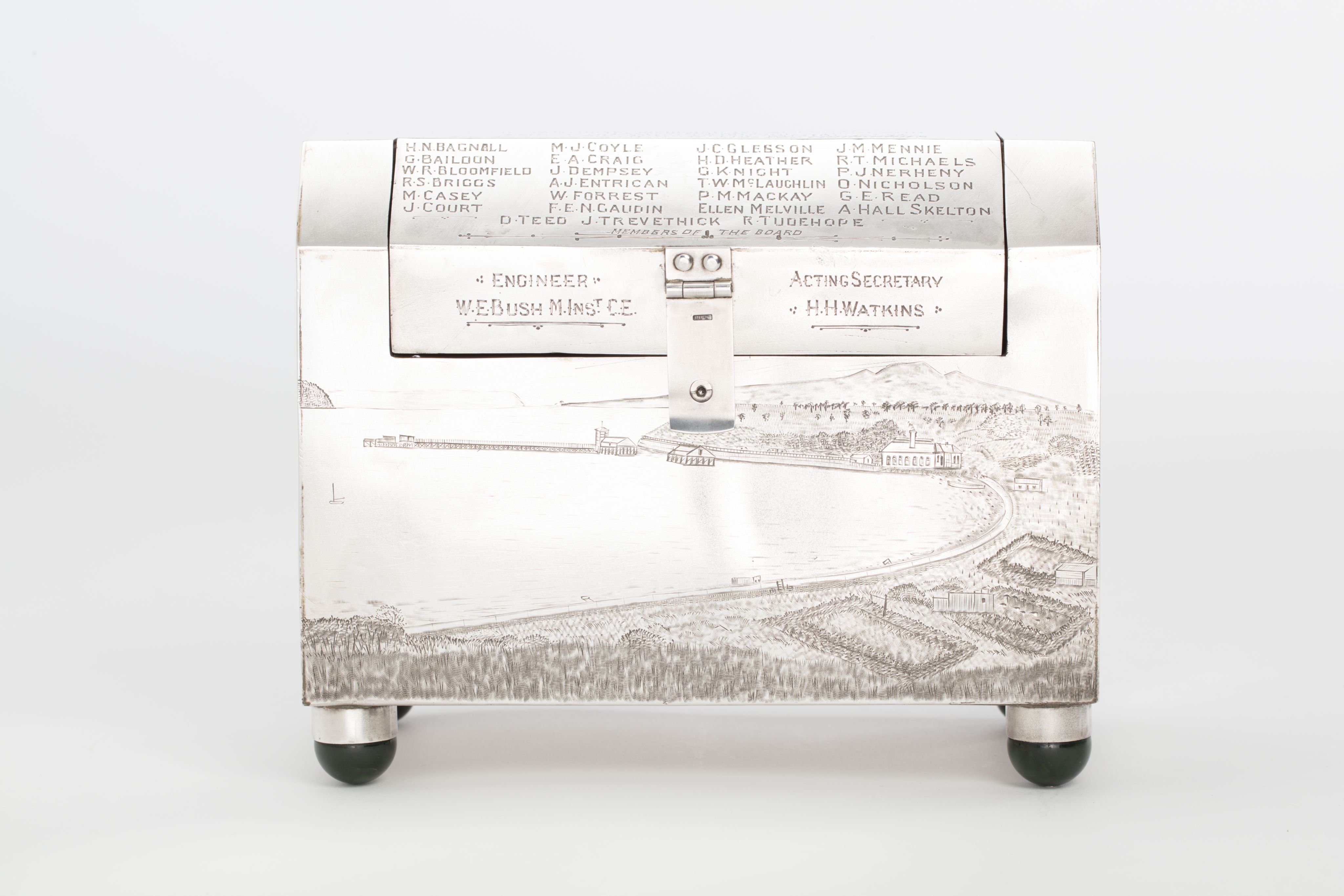 Finely crafted silver box (or casket) designed in the shape of the main sewage pipe, engraved with the names of the members of the drainage board along with technical sewage . On one side there is an engraved illustration of Ōkahu Bay, showing the Ngāti Whātua Ōrākei papakāinga and the newly installed sewer pipe running along the foreshore in front of it.